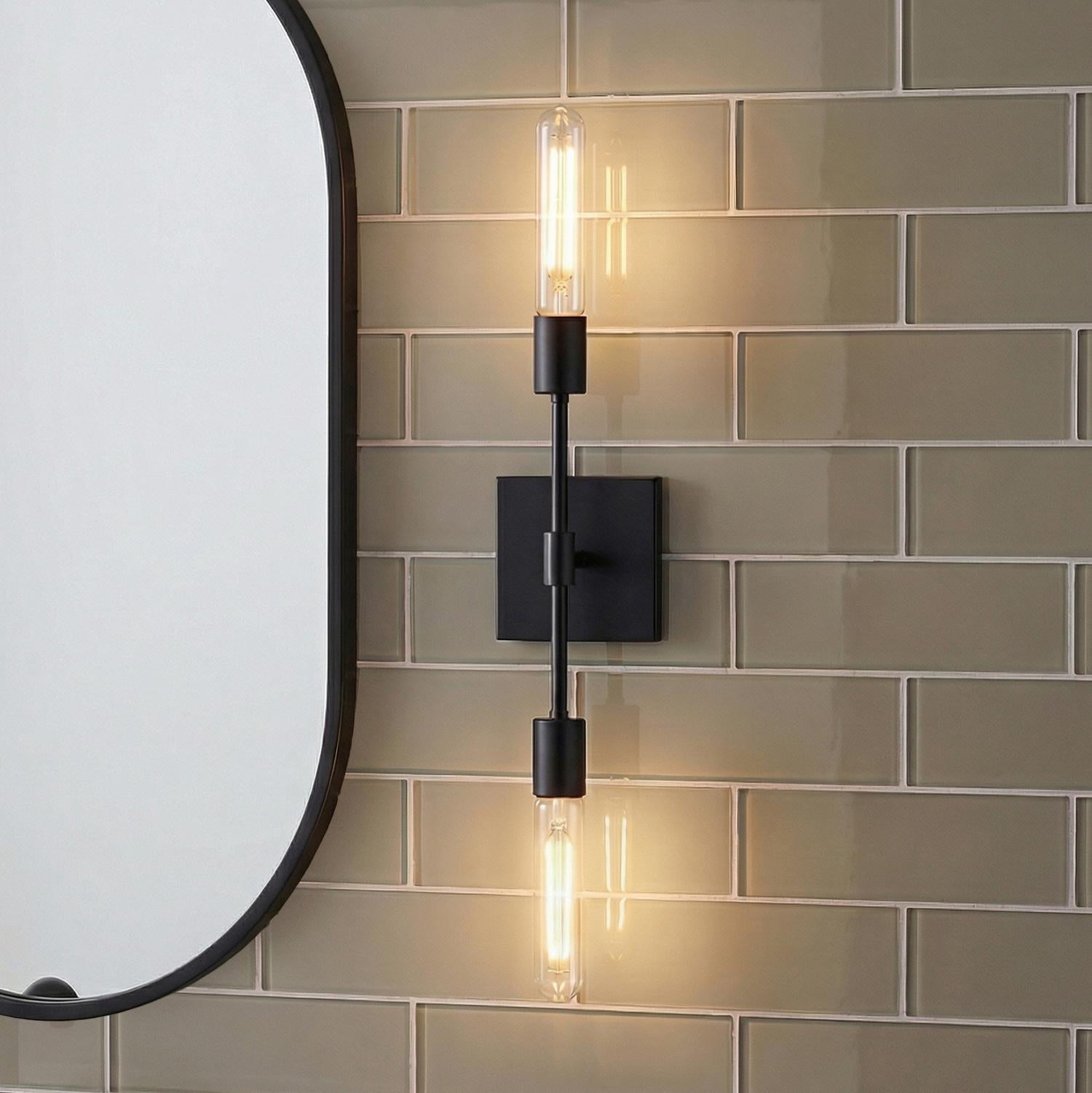 Prospect 2 Light Wall Sconce, Matte Black linear Wall Sconce in a Contemporary Bathroom with green subway tile and an oval mirror.