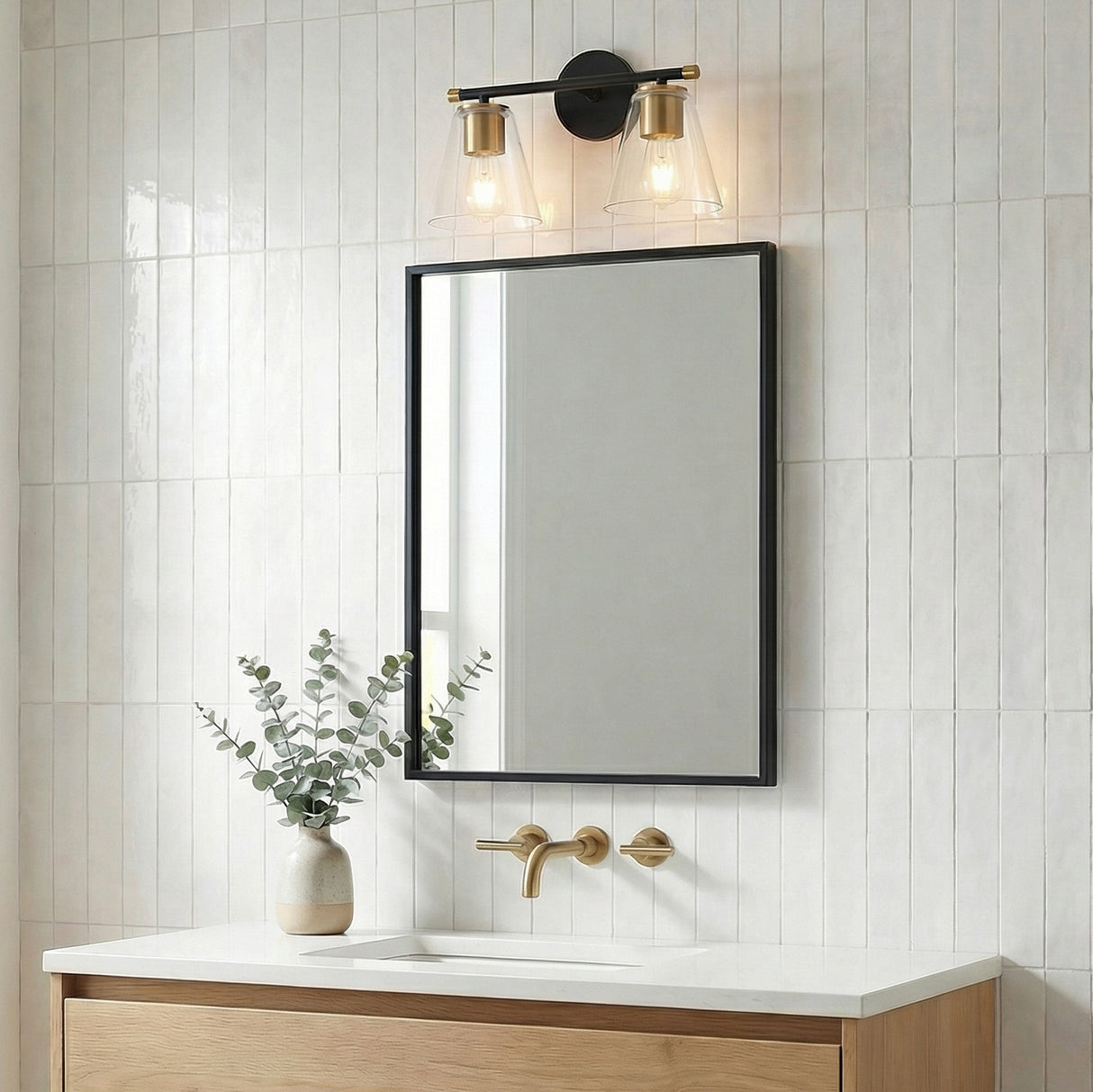 Carlisle 2 Light Vanity, Matte Black and Brushed Brass with Clear Glass geometric vanity light in a Modern Bathroom with white subway tile.