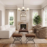 A transitional living room features the Ryan 5 Light Chandelier 30 in Matte Black and Aged Brass hung above a dark wood coffee table and marble fireplace.