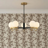 Arlo 5 Light Chandelier 30", Matte Black and Aged Brass globe Chandelier in a Transitional Dining Room with floral wallpaper.