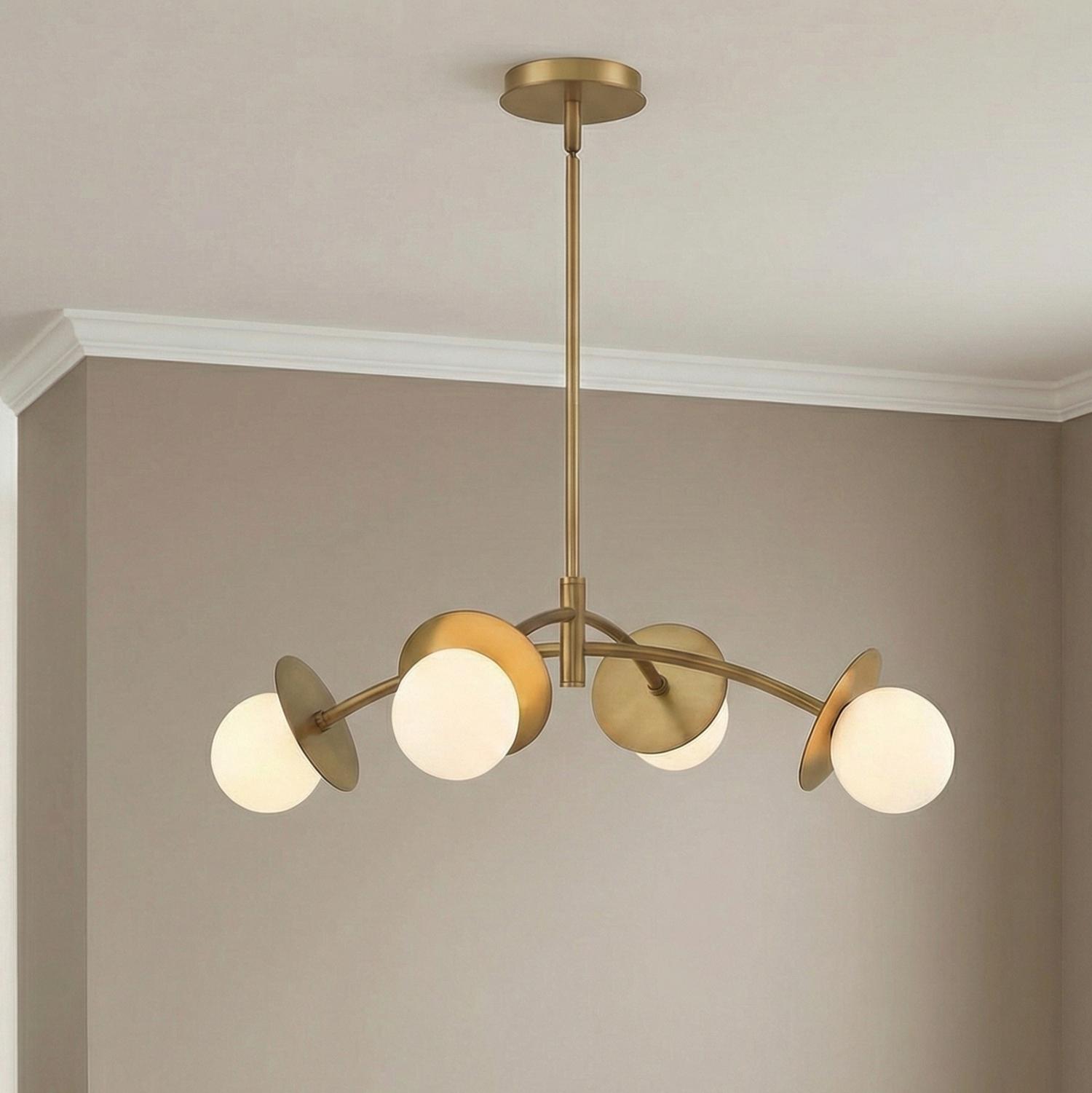 Levi 4 Globe Chandelier, Aged Brass globe Chandelier in a Contemporary Dining Room with taupe walls and white crown molding.