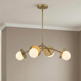 Levi 4 Globe Chandelier, Aged Brass globe Chandelier in a Contemporary Dining Room with taupe walls and white crown molding.