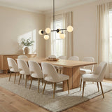 Matte Black globe linear pendant in a Transitional Dining Room with a light oak dining table and cream chairs.