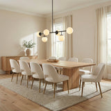 Matte Black globe linear pendant in a Transitional Dining Room with a light oak dining table and cream chairs.
