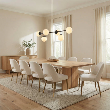 Matte Black globe linear pendant in a Transitional Dining Room with a light oak dining table and cream chairs.