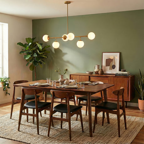 Castell 6 Globe Linear Pendant 46", Brass globe linear pendant in a Mid-Century Dining Room with a wooden dining table and green accent wall.