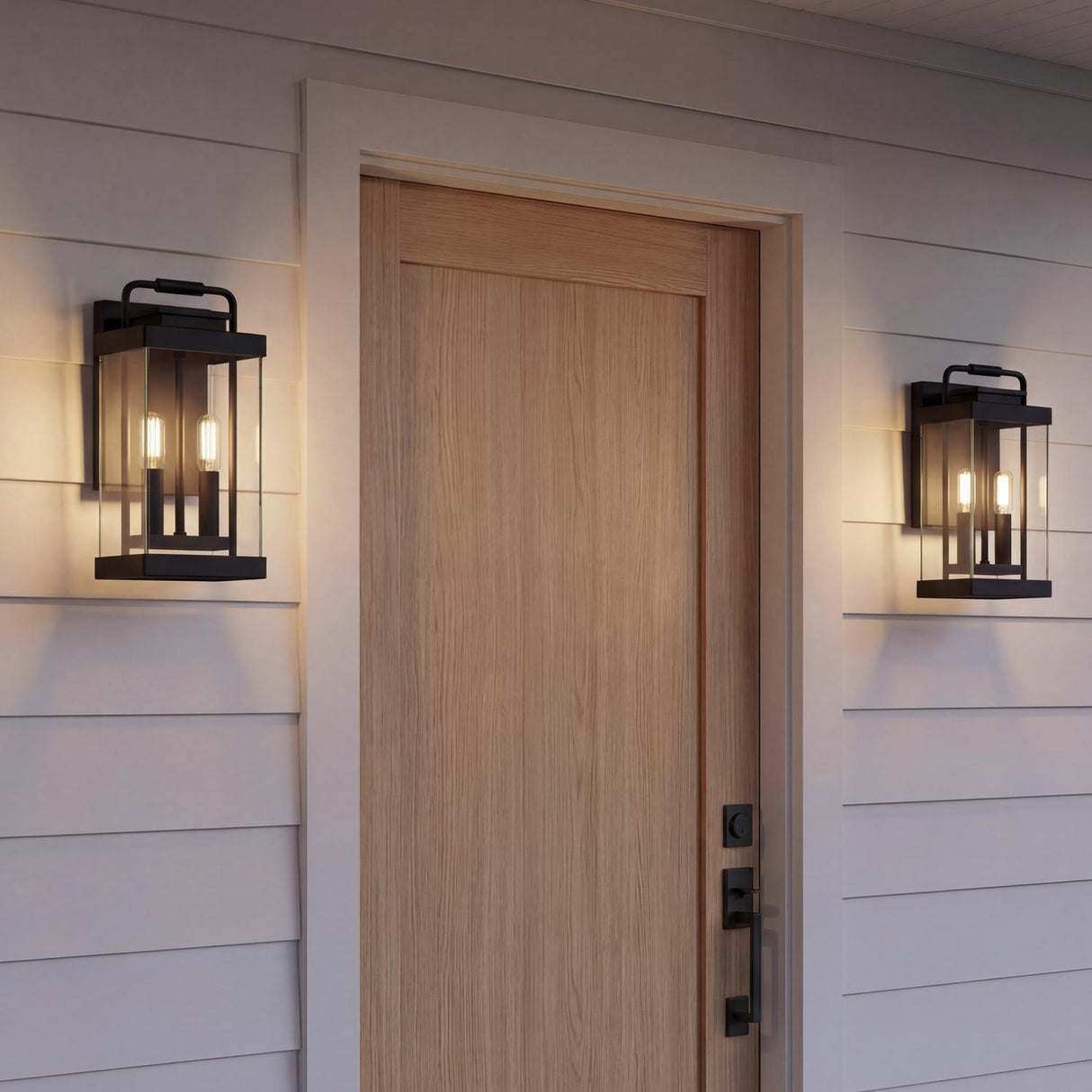 An outdoor entryway with two matte black Parker Outdoor Wall Light lanterns flanking a light wood door set against white horizontal siding.