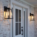 Ira Outdoor Wall Light, Small Matte Black geometric Outdoor Wall in a Modern Farmhouse Outdoor with white brick and a glass front door.