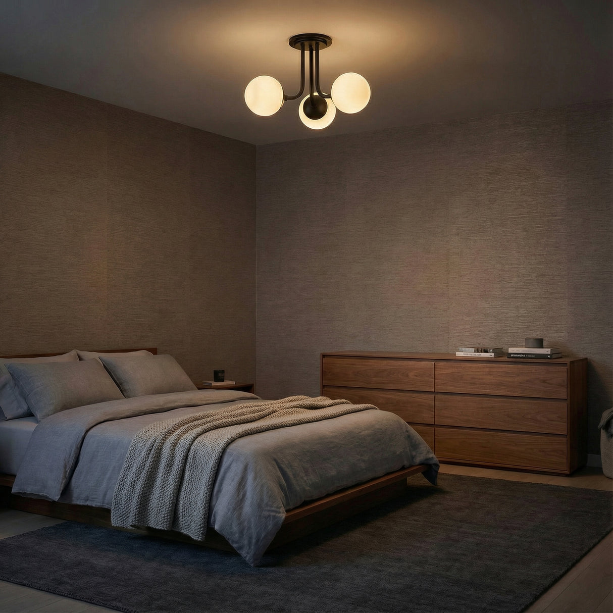 Aria 3-Light Matte Black globe semi-flush mount in a Modern Bedroom with a wooden bed and dresser.