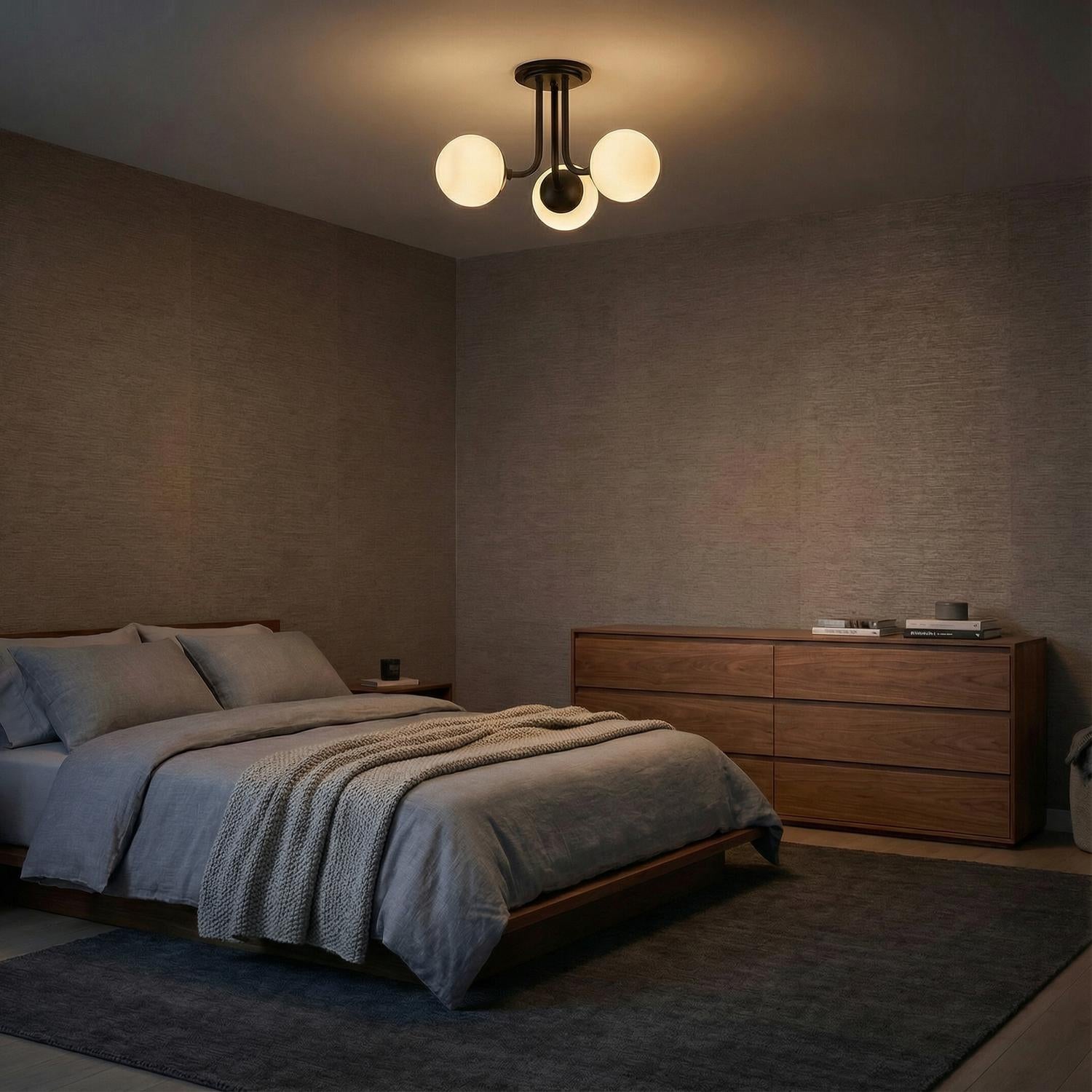 Aria 3-Light Matte Black globe semi-flush mount in a Modern Bedroom with a wooden bed and dresser.
