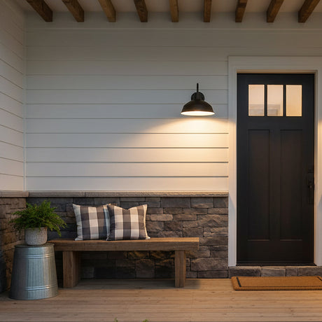 Asher Large Outdoor Wall Light, Black - A black outdoor wall light illuminating a porch with a bench and black door.