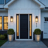 Sam Outdoor Wall Light, Medium 18" Matte Black geometric outdoor wall sconce in a Modern Farmhouse Outdoor with board-and-batten siding and black door.