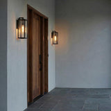 Sam Outdoor Wall Light, Medium 18" Matte Black geometric Outdoor Wall in a Modern Farmhouse Entryway with a wood door and slate floor.