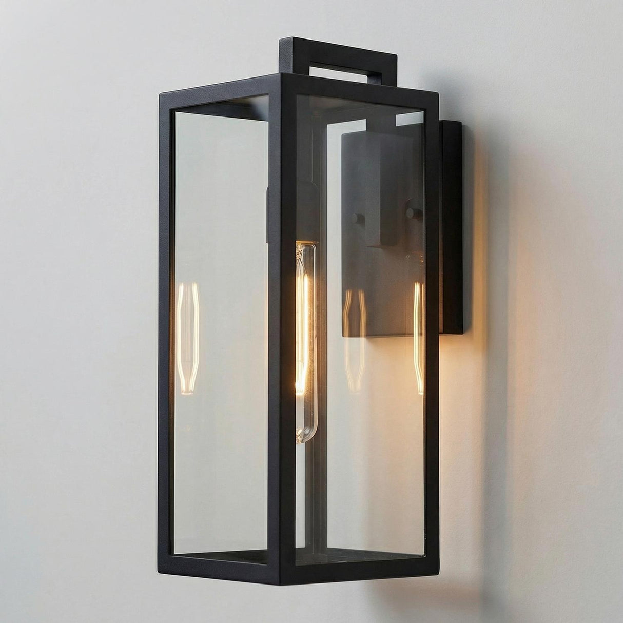 Sam Outdoor Wall Light, Medium 18" Matte Black geometric Outdoor Wall in a Modern Outdoor entryway with a white stucco wall.