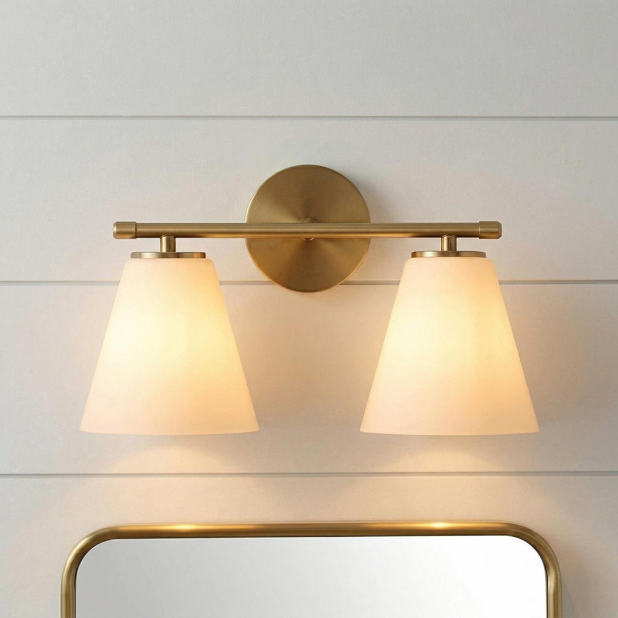Carlisle 2 Light Vanity, Brushed Brass geometric wall light in a Modern Farmhouse Bathroom with shiplap and a brass mirror.