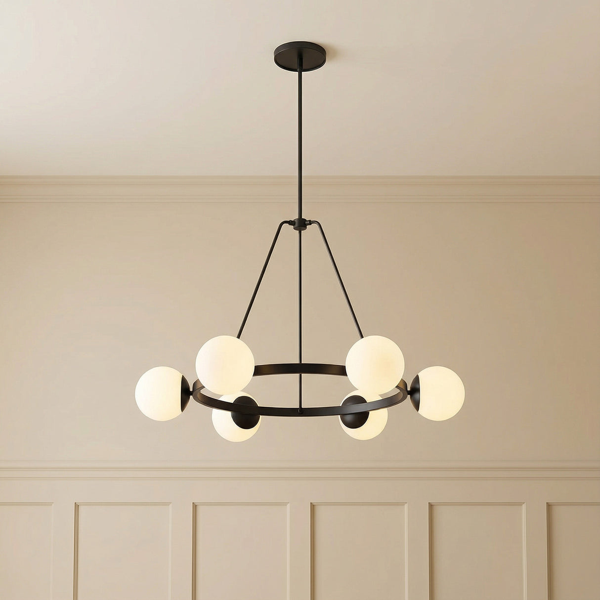 Castell 6 Globe Round Chandelier 36", Matte Black globe design chandelier in a Transitional Living Room with paneled walls.