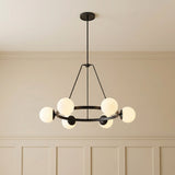 Castell 6 Globe Round Chandelier 36", Matte Black globe design chandelier in a Transitional Living Room with paneled walls.