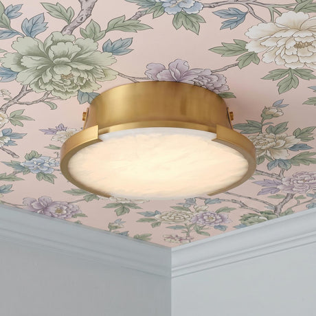 A transitional foyer featuring the Joni LED Alabaster Flush Mount 14 inch in aged brass installed along a ceiling with pink floral wallpaper and white crown molding.
