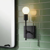 Prospect Wall Sconce, Matte Black globe design Wall Sconce in a Modern Bathroom with green subway tile and a black mirror.