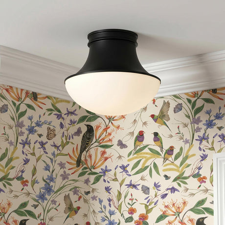 A traditional foyer with a matte black flush mount and frosted glass shade along the ceiling featuring vibrant bird and floral wallpaper and white crown molding.