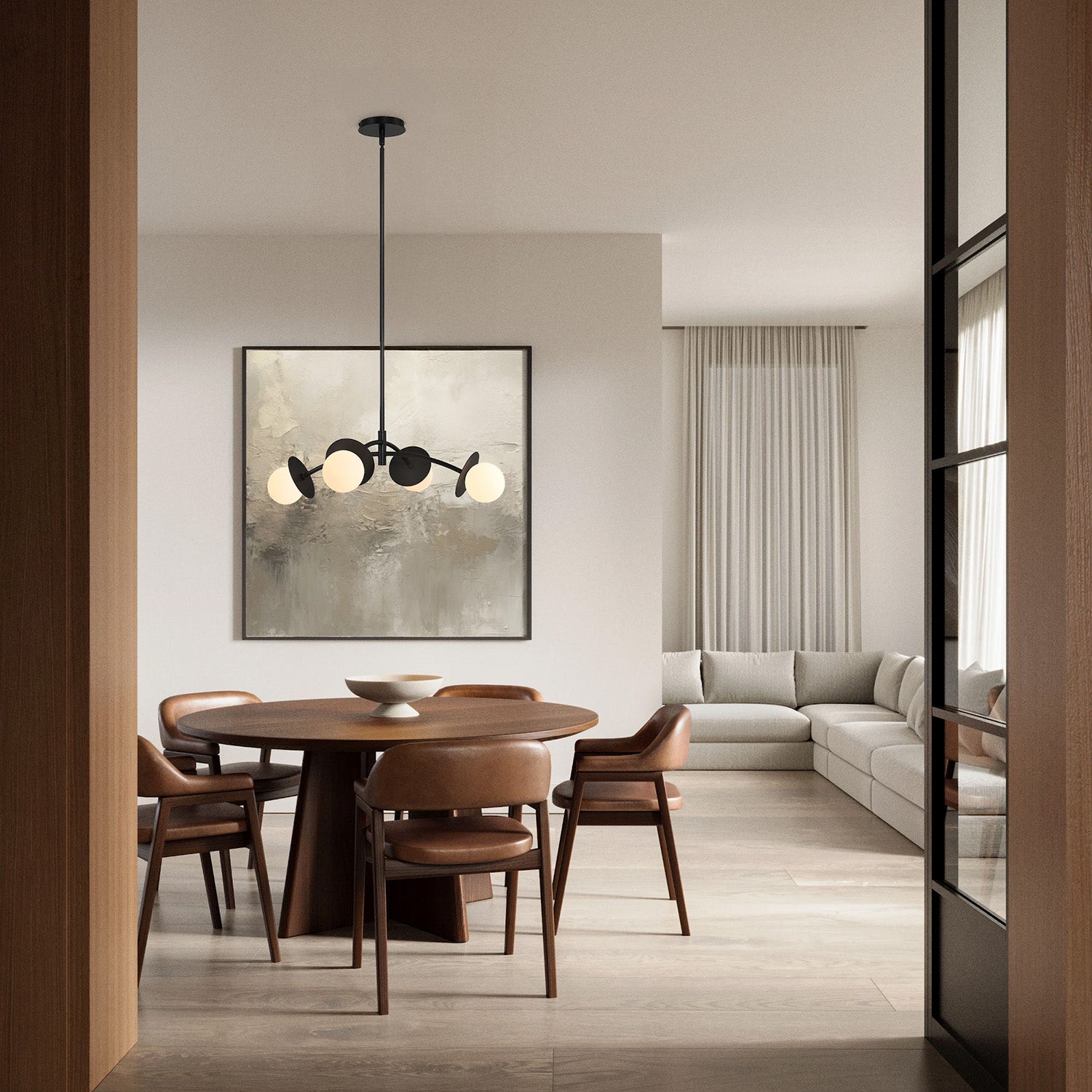 Levi pendant in black, shown in a modern dining room witha  wooden table and chairs, light gray sofa, and abstract art on the wall.