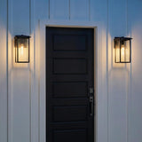 Colin Outdoor Wall Light, Medium Matte Black geometric Outdoor Wall Light in a Modern Farmhouse Outdoor with a black door and white siding