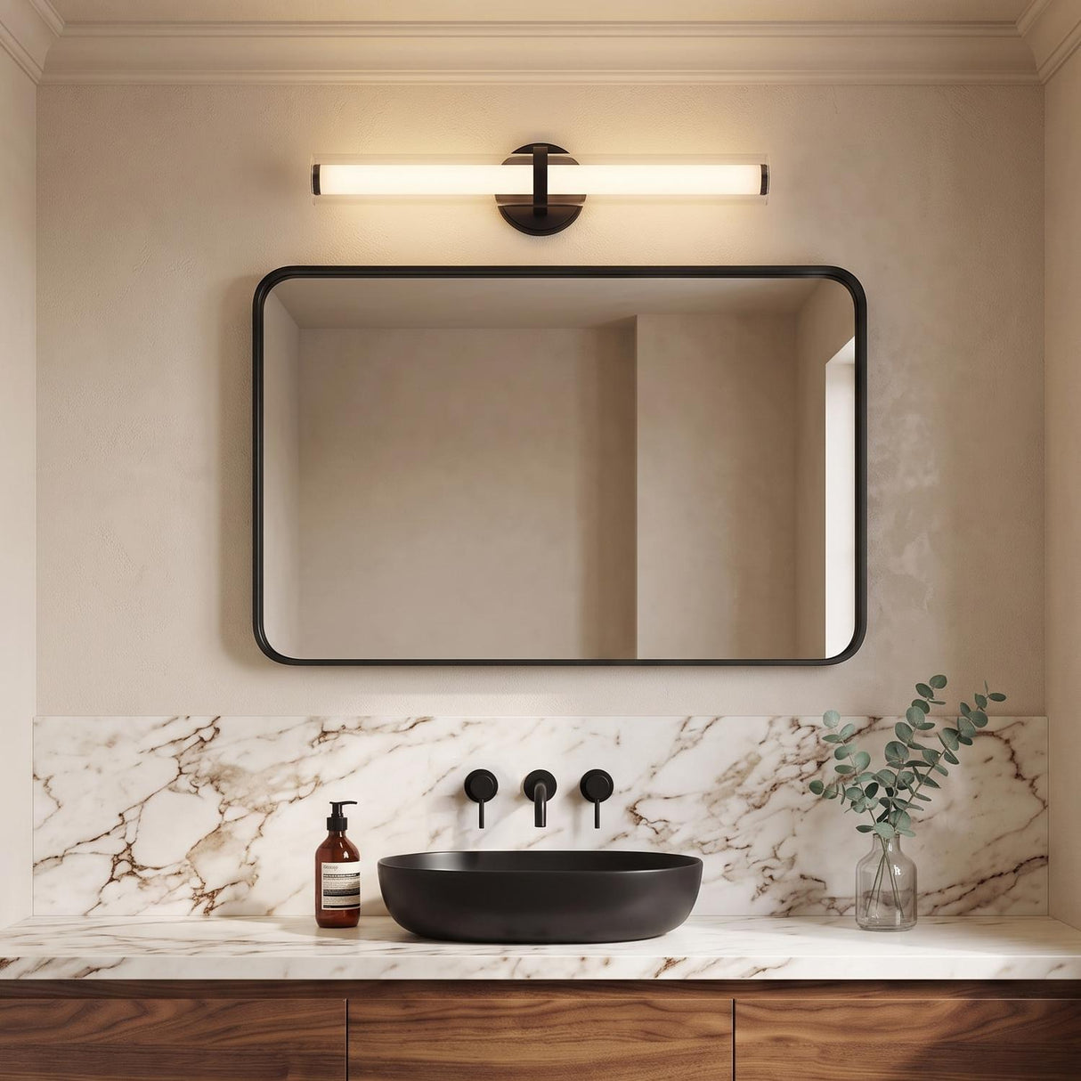 A modern bathroom featuring the Ellie LED Vanity Light in matte black and glass mounted above a black-framed mirror, white marble backsplash, and a vessel sink.