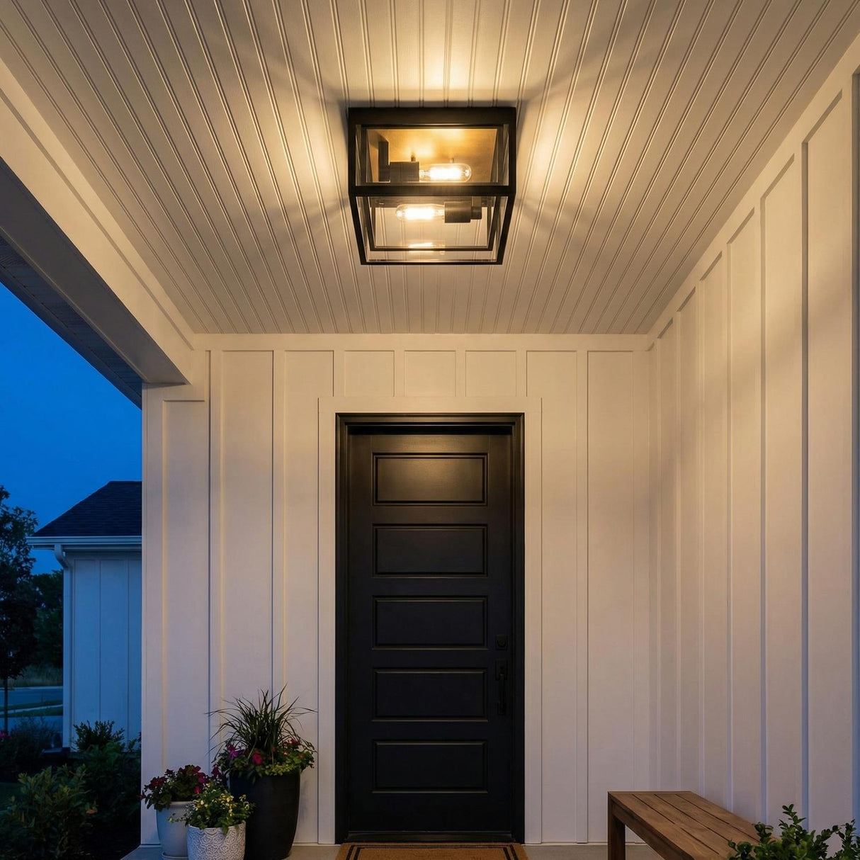 Jaxon Matte Black geometric flush mount in a Modern Farmhouse Outdoor entryway with a black door and white board and batten walls.