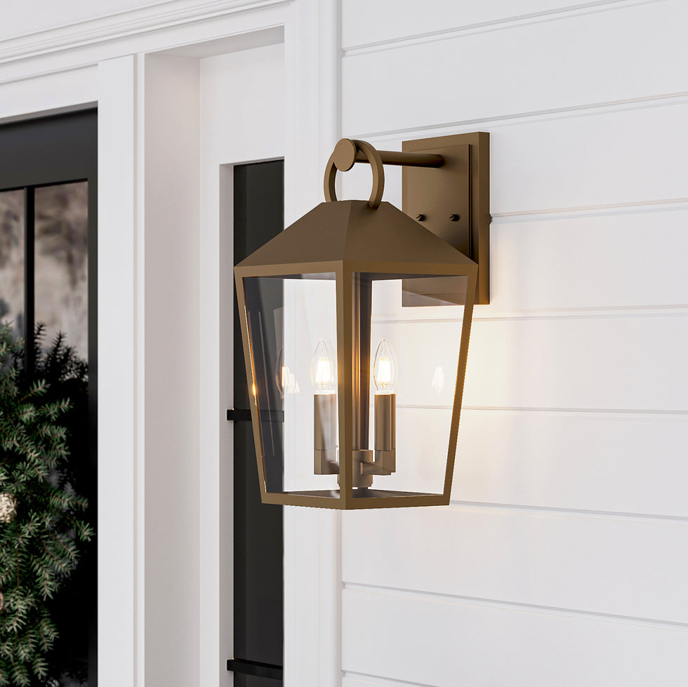 Outdoor Burnished Brass Lantern Wall Light, Cole Collection, on a wintery porch with white cladding and a wreath on the door