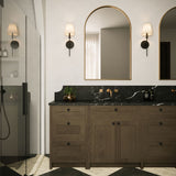 Two Taylor 19" Wall Sconces, Matte Black with White Fabric Shade, shown in a traditional luxe bathroom, flanking an arched vanity mirror. 
