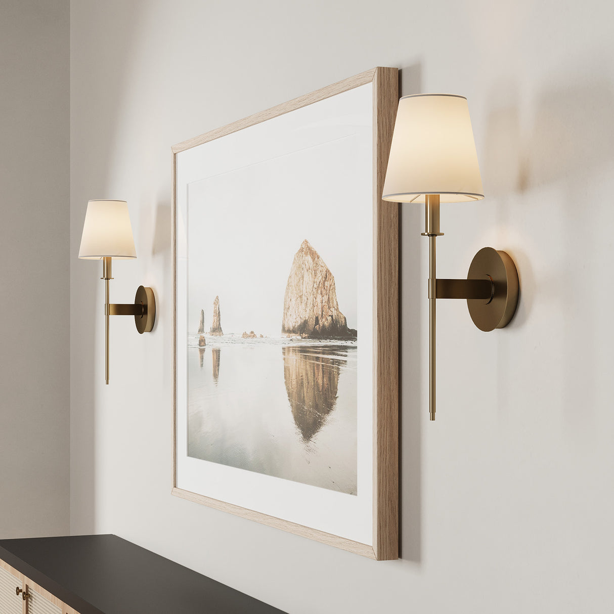 Close-up of two Taylor 19" Wall Sconces,  Aged Brass with White Fabric Shades,  flanking a piece of wall art

