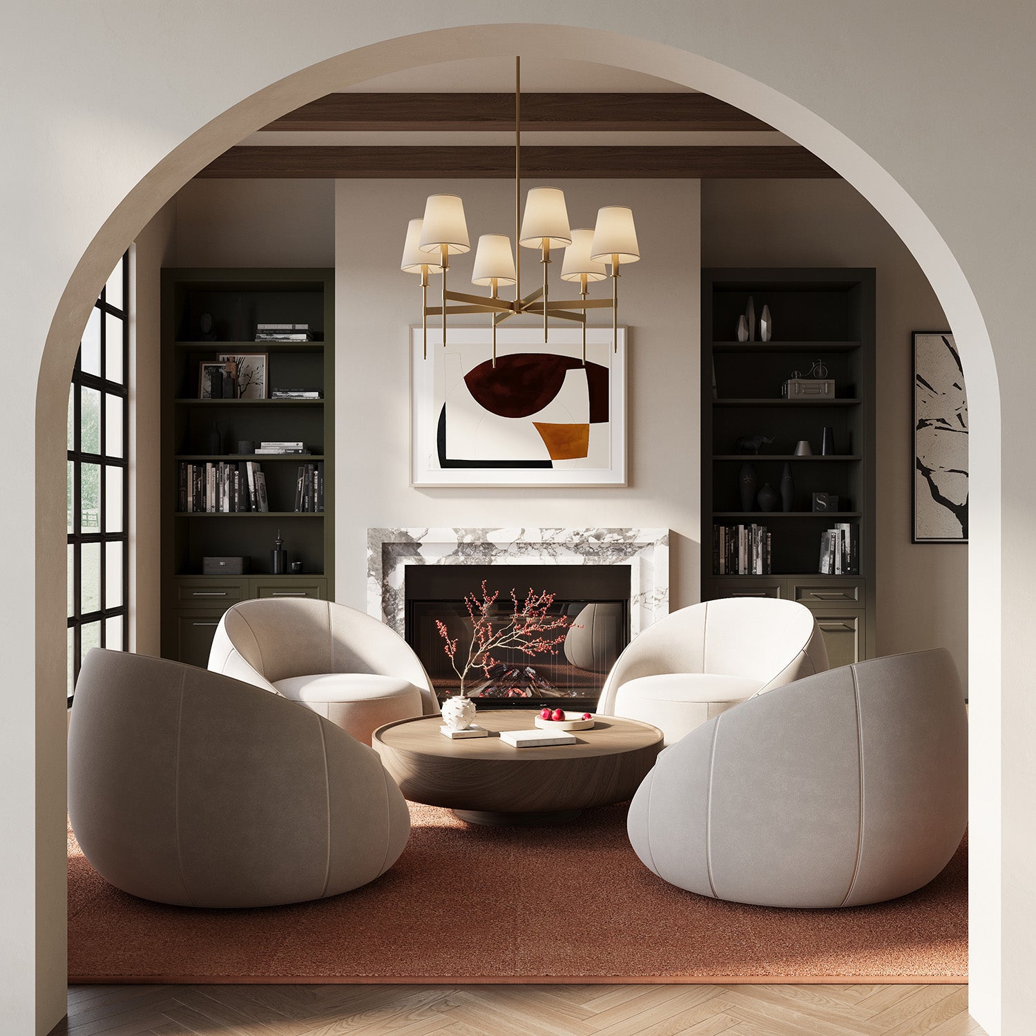 Taylor six light Chandelier in aged brass with white fabric shades, shown in a loving room with four rounded barrel chairs, modern art, and a marble fireplace.