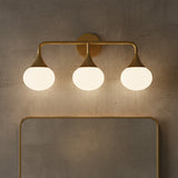 Talia 3 Light Vanity, Aged Brass for Modern home with Gray Concrete