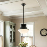 A transitional kitchen featuring a matte black Jayden Pendant 14" with a white glass shade suspended from a coffered ceiling near sage green cabinetry.