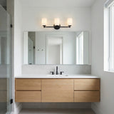 Becca 3 Light Vanity, Matte Black geometric vanity light in a Modern Bathroom with a floating wood vanity.