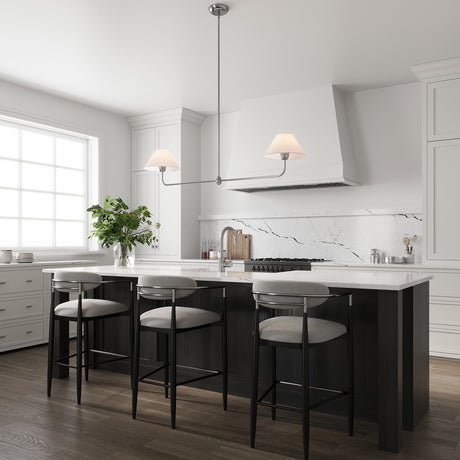 Holden 2 Shade Linear 57" Pendant, Polished Nickel with White Fabric Shades, hung in a bright white kitchen with black wood island.