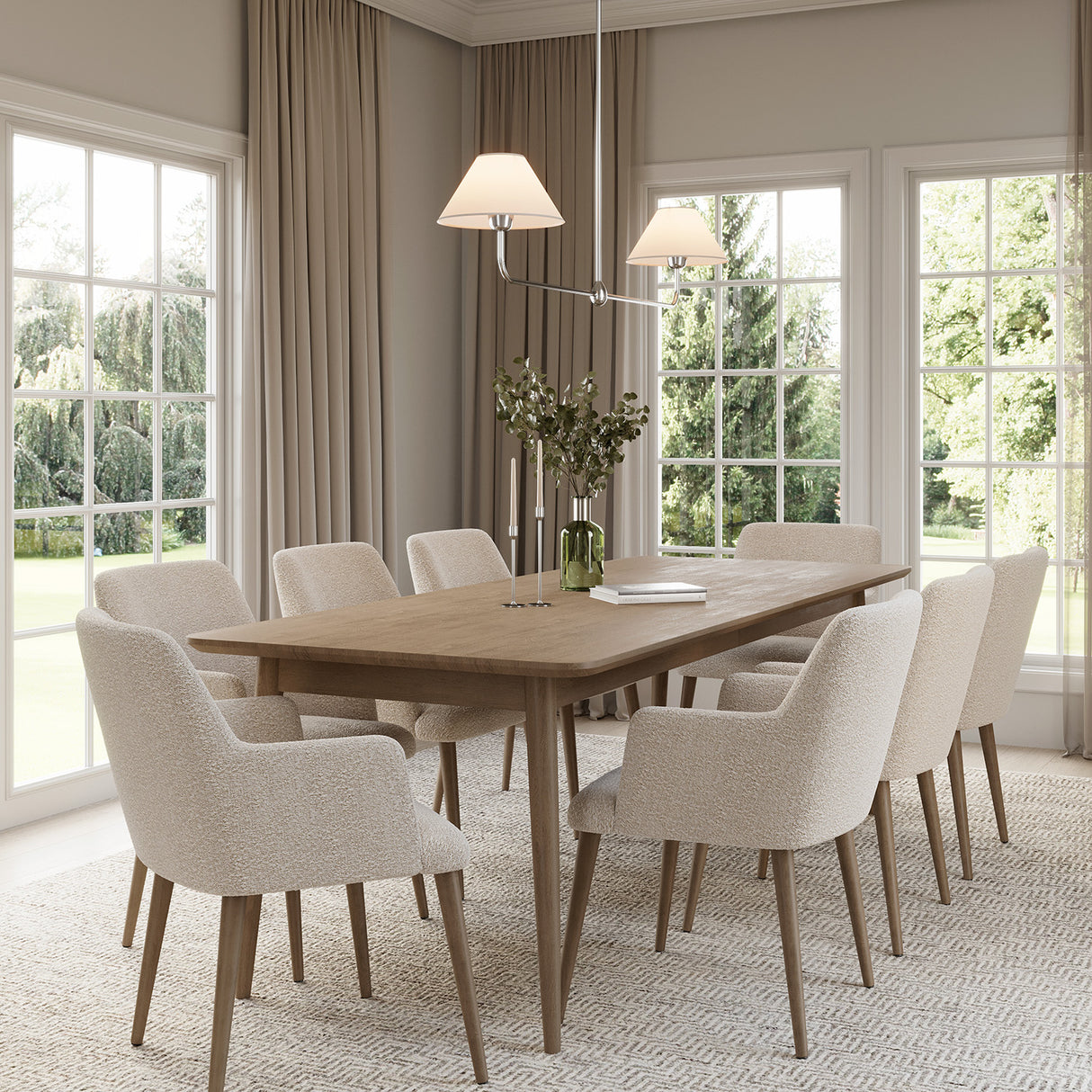 Holden 2 Shade Linear 57" Pendant, Polished Nickel with White Fabric Shades, hung in a dining room above a natural wood table with seating for eight.