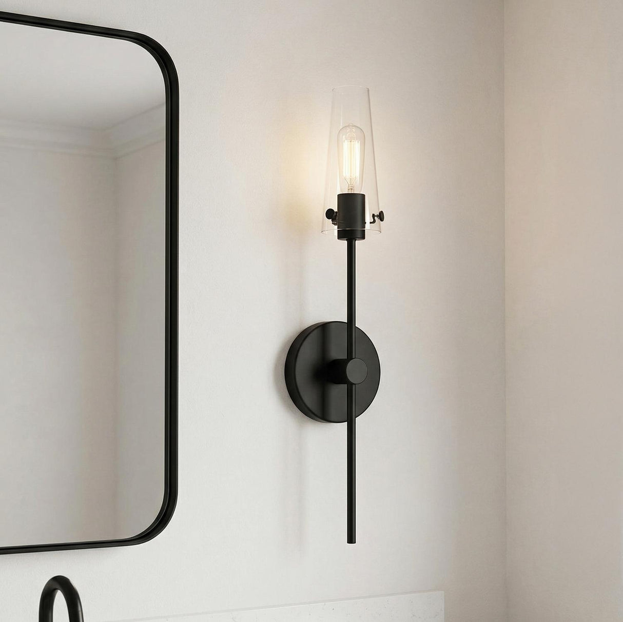 Mason 1 Light Wall Sconce Matte Black linear Wall Sconce in a Contemporary Bathroom with a black framed mirror.