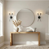 Matte Black geometric Wall Sconce in a Modern Entryway with a natural wood console table and round mirror.