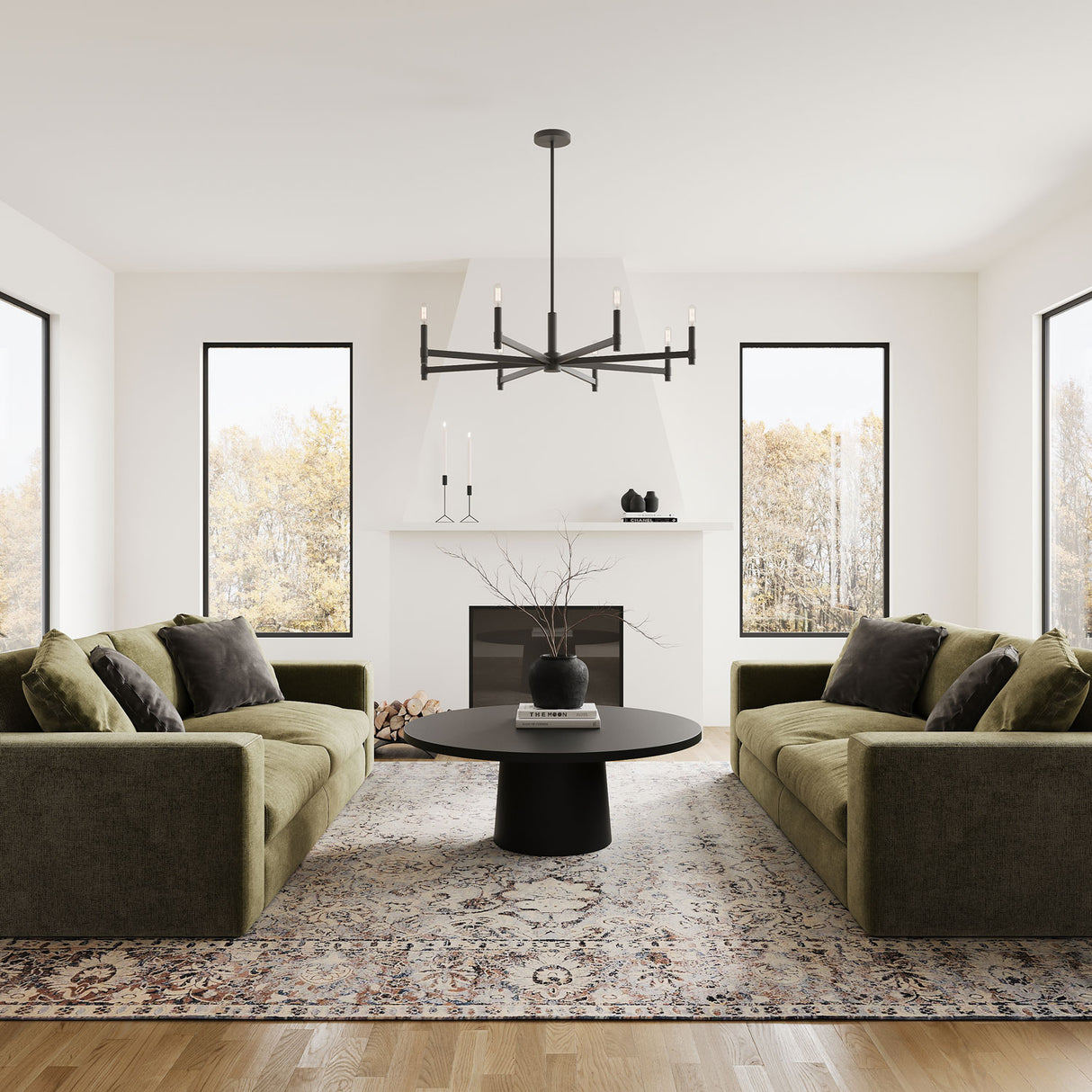 Carson 8 Light 36" Modern Chandelier, Matte Black, shown in a living room with green velvet sofas and a round black coffee table, centered in front of a white fireplace mantel