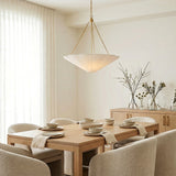 Liza Linen Pendant 28", White and Aged Brass scalloped pendant in a Transitional Dining Room with a light oak table and bouclé chairs.