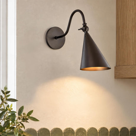A transitional kitchen features the Faye Adjustable Metal Wall Sconce, Old Bronze mounted on a textured beige wall above green scalloped backsplash tile and oak cabinetry.