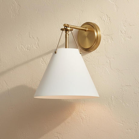 Bowie Wall Sconce, White and Brass - A white and brass wall sconce mounted on a textured beige wall.