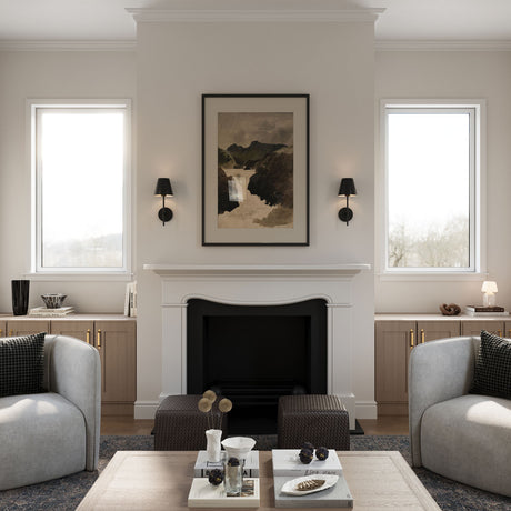 Two all black metal Banks sconces, shown flanking a black and white art piece above a fireplace