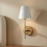 Banks Wall Sconce, White and Brass geometric Wall Sconce in a Transitional Bedroom with a textured headboard and wood nightstand.