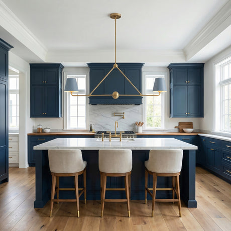Modern kitchen with blue cabinets, white island, and a french blue linear metal pendant with brass accents