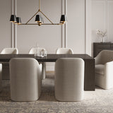 Banks Metal Linear Chandelier, with 6 lights and 46" wide, shown in Matte Black and Brass, is hung over a contemporary dark wood dining table, with seating for eight. 