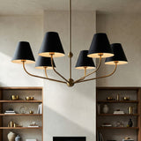 Banks 6 Light Chandelier 40", Matte Black and Brass geometric chandelier in a Modern Living Room with minimalist wooden shelves.