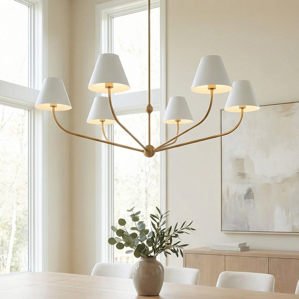 Banks 6 Light Chandelier 48", White and Brass Brass linear Chandelier in a Transitional Dining Room with a light wood table and abstract art.