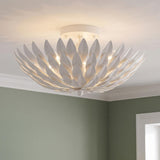 A contemporary room featuring the Alysa Semi-Flush 16", Matte White fixture mounted on the ceiling above soft sage green walls with crisp white crown molding.
